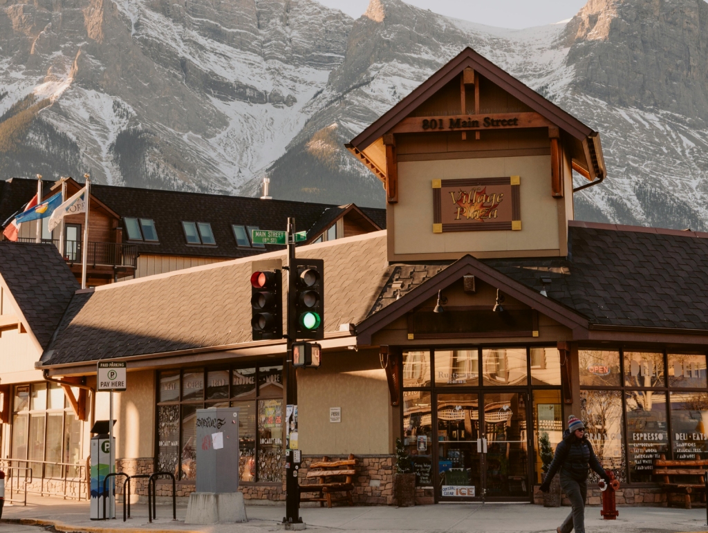 Grocery store with snow-covered mountain in the background 