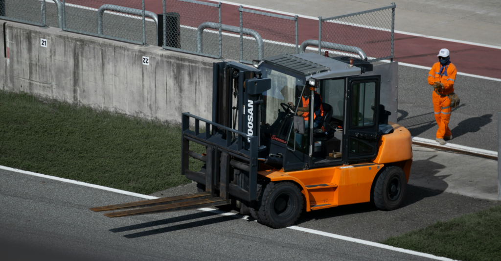 Forklift with a person in the background 